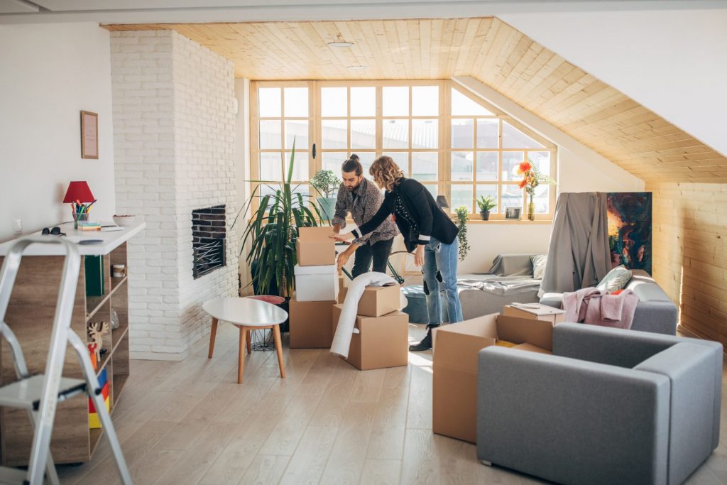 Man and woman, young couple moving into their new apartment together.