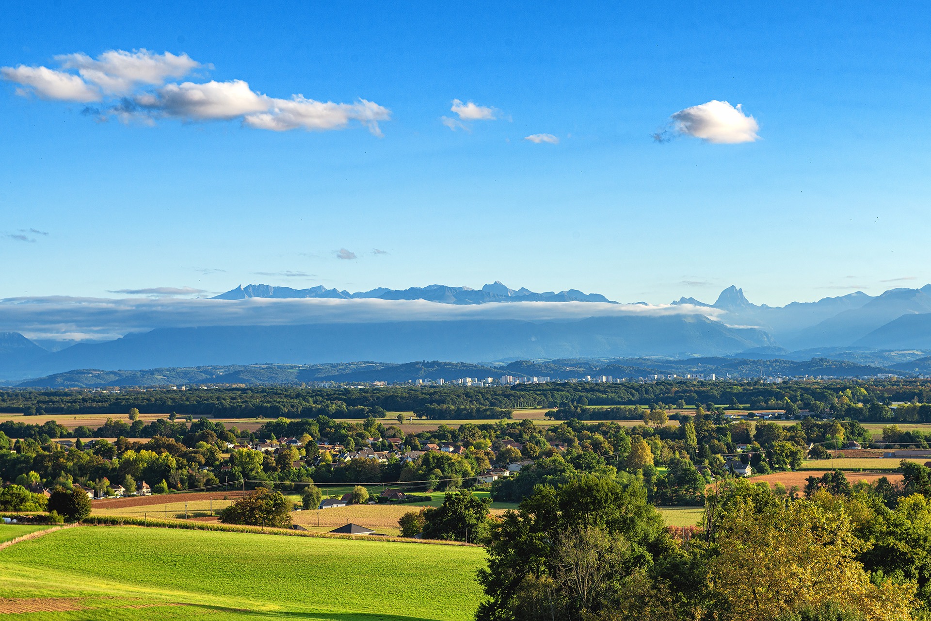 a landscape of Pau city, Pyrenees mountains on background