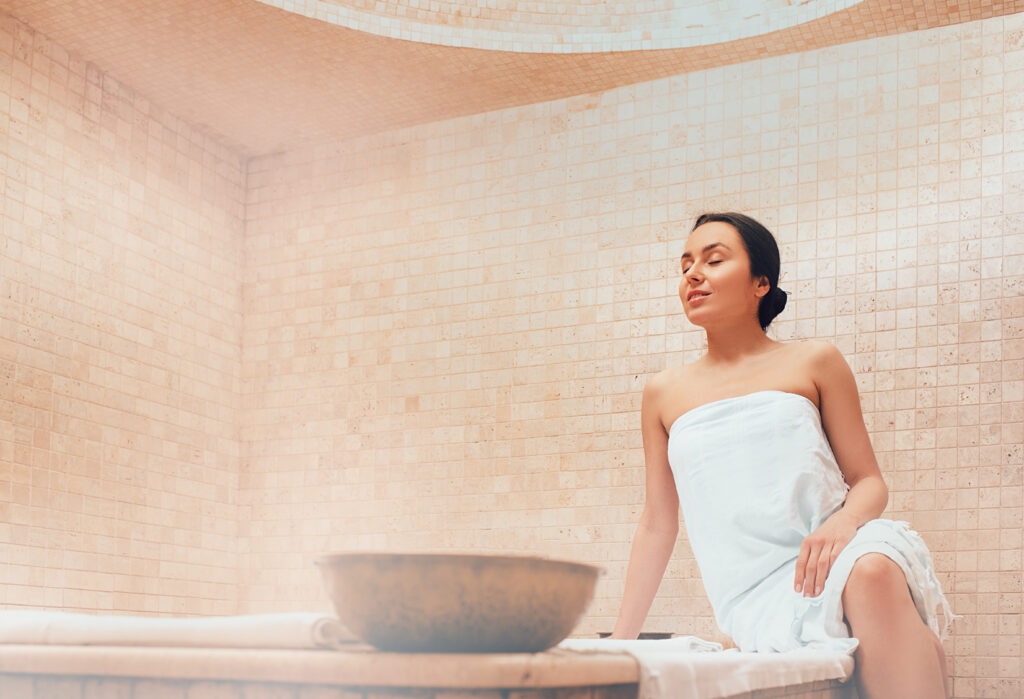 Attractive woman relaxing at hammam. Body recovery at hamam, traditional turkish bath