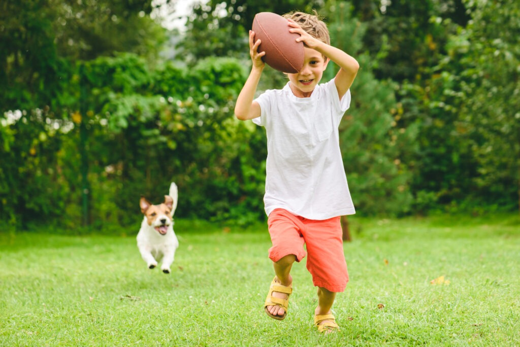 Two friends having fun at backyard at sunny summer day